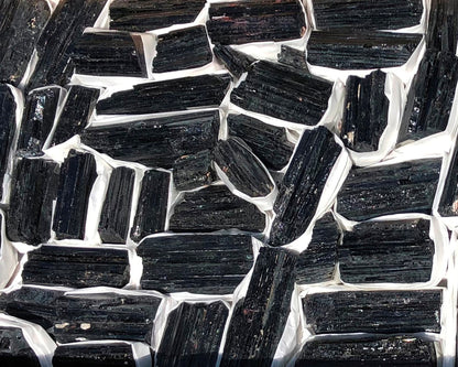 Ansicht von oben: Vielzahl an Turmalin Kristallen auf weißem Hintergrund