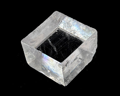 optischer Calcit mit Lichtbrechung auf schwarzem Hintergrund