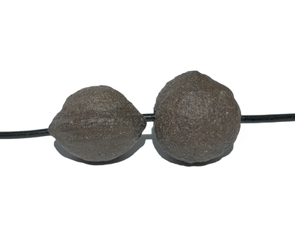 Moqui Marbles mit Band auf weißem Hintergrund