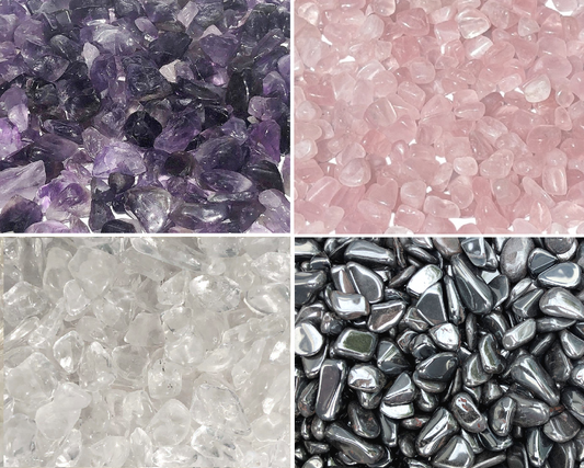 Amethyst Bergkristall Rosenquarz Hämatit Trommelsteine nebeneinander auf weißem Hintergrund